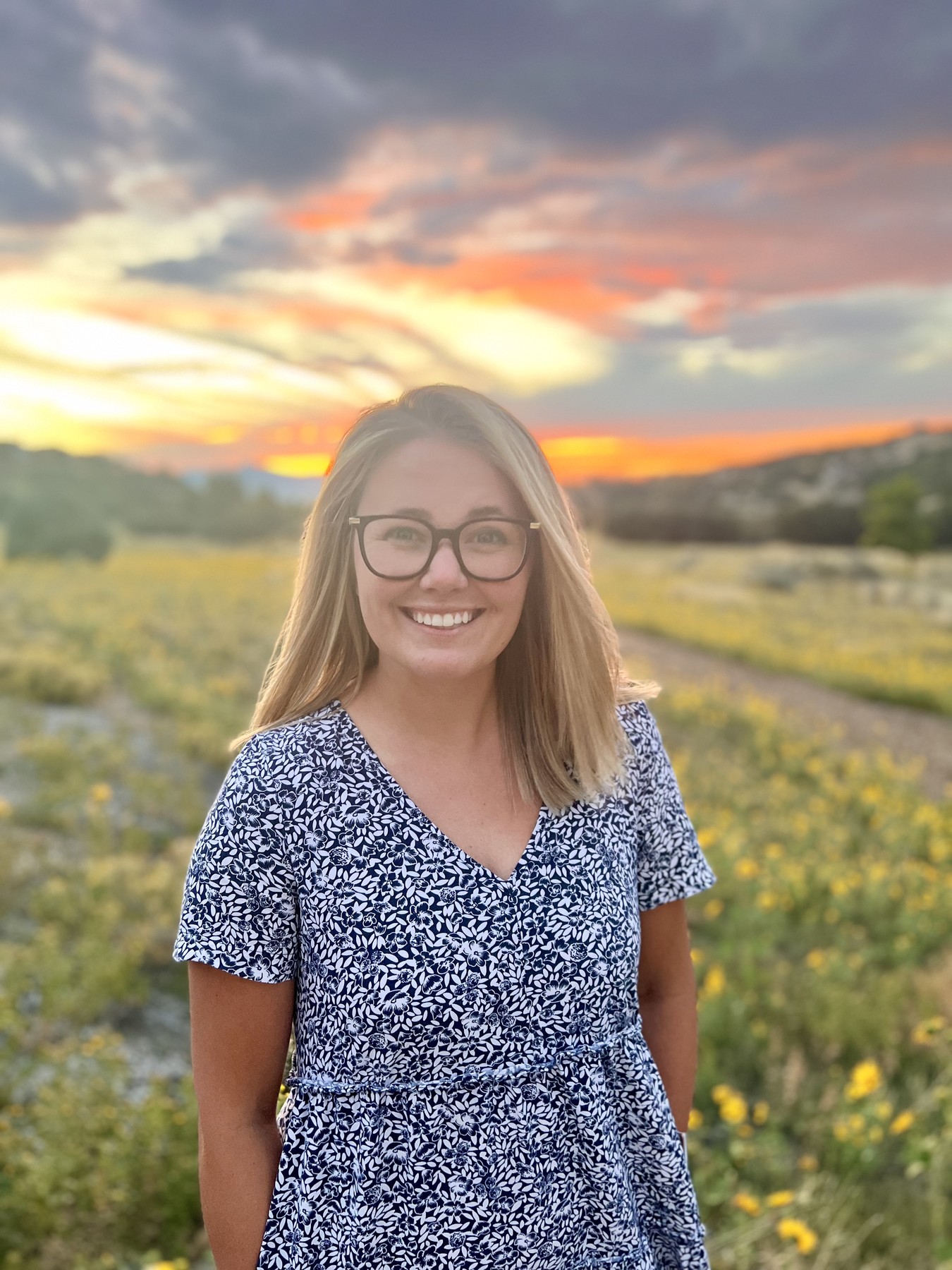 Claire Proudfoot smiling outdoors at sunset